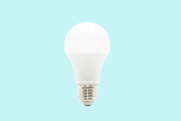 Close up LED white light bulb isolated on blue background. Clipping path -Image. Close up LED white light bulb isolated on blue background. Clipping path -Image. tungsten image stock pictures, royalty-free photos & images