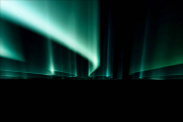 istock green northern lights against black back ground. 1132520731