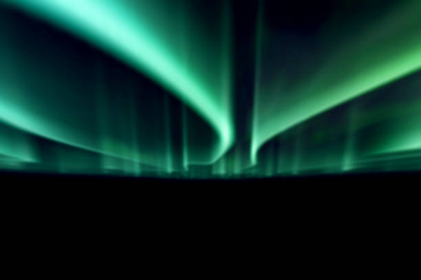 istock green northern lights against black back ground. 1132522289