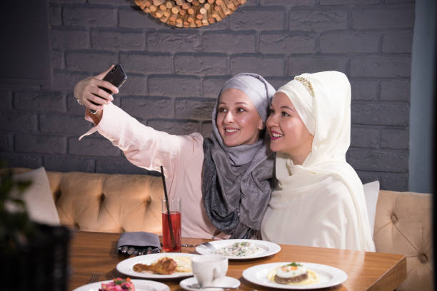 istock Two Muslim girl take a selfie at a table in a cafe 1132522537