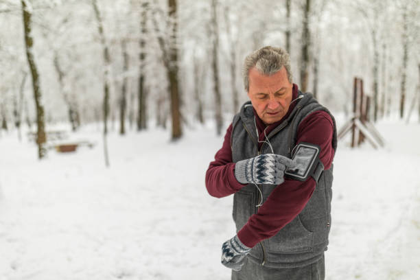 istock Senior man jogging in snow 1132523620