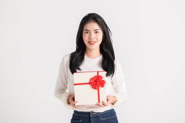 istock Happy pretty young woman holding gift box 1132523725
