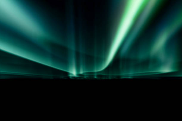 Photo of green northern lights against black back ground.
