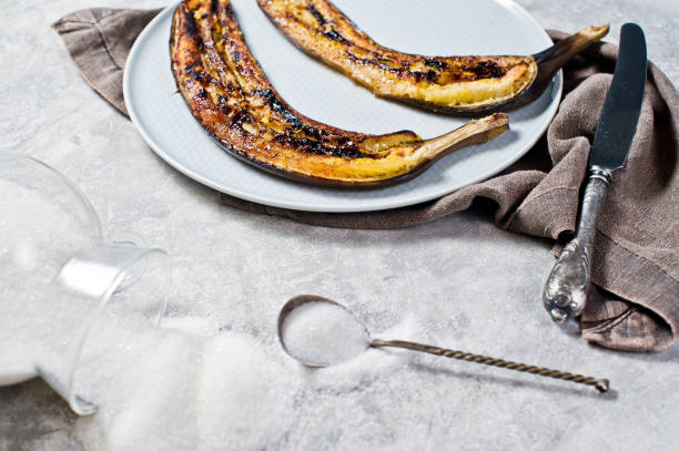 istock Fried bananas with honey on a grey plate. Gray background, side view. 1132525908