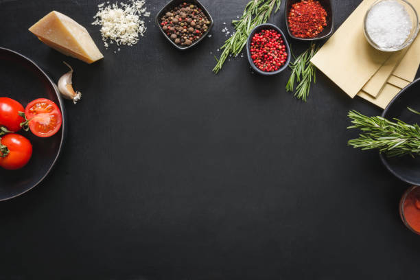 istock Raw ingredients for lasagna, pasta,vegetables and herbs on black. Copy space. 1132526019