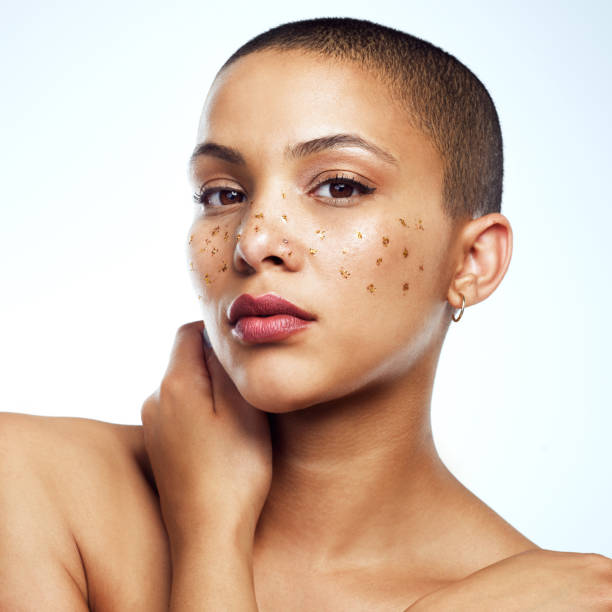 Studio shot of a beautiful young woman posing with glitter freckles on her face