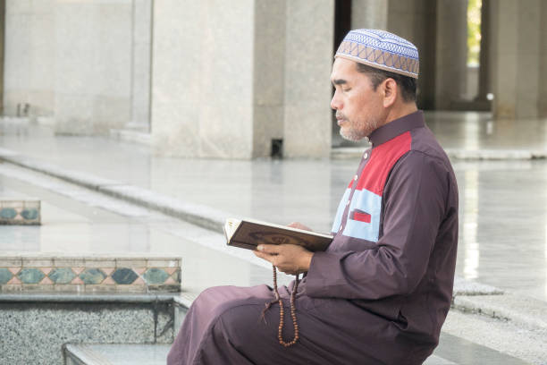 istock Mature Man Reading Koran While Sitting At Mosque 1132526825