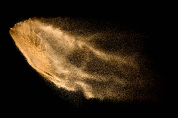 istock Yellow sand explosion isolated on black background. Abstract sand cloud. 1132528174