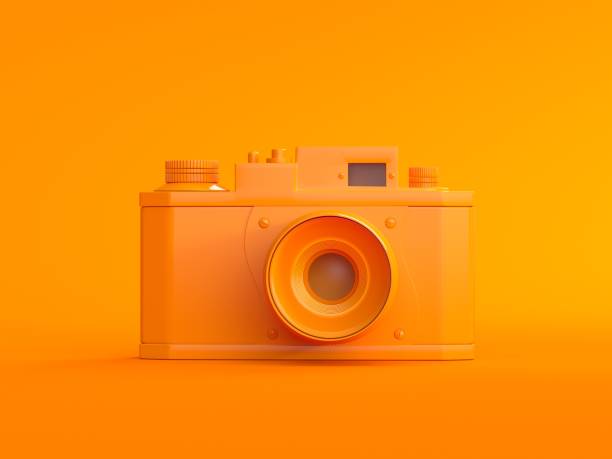 istock 3D Digital orange photo camera on orange background 1132536059
