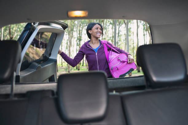 istock Woman unpacking car trunk. 1132538104
