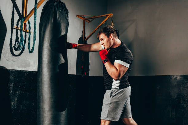 istock Fighter man training in heavy bag at gym 1132538349