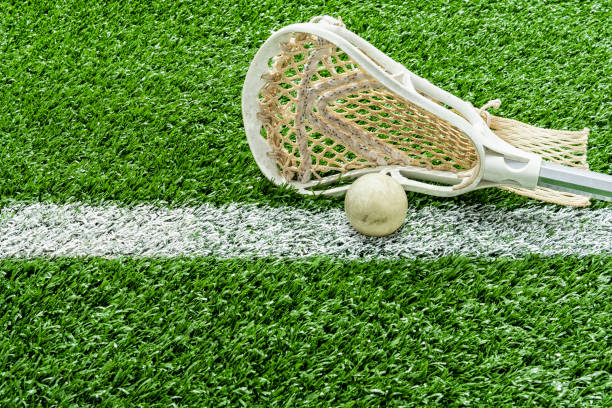 istock Looking down on a Lacrosse stick and a ball on the midfield-line 1132538986