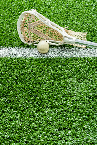 istock Looking down on a Lacrosse stick and a ball on the midfield-line 1132538996