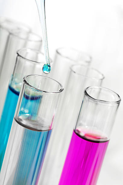istock liquid dripping from pipette into test tube 113254024