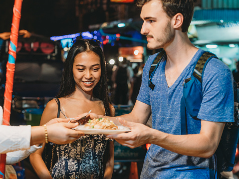 Young couple looking for street food in Bangkok