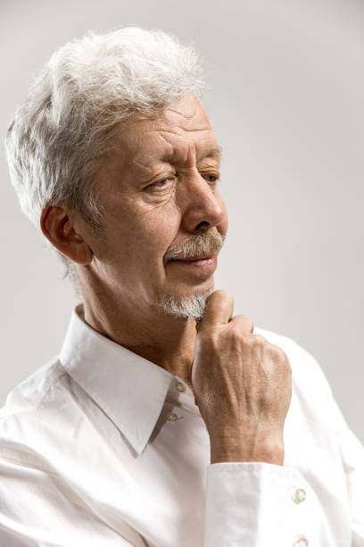 istock The serious businessman against gray background. 1132541742