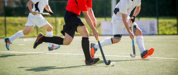 istock Low Section Of Men Playing Hockey On Turf 1132543755