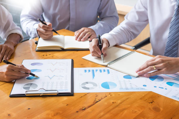 istock Midsection Of Business People Working At Table In Office 1132543817