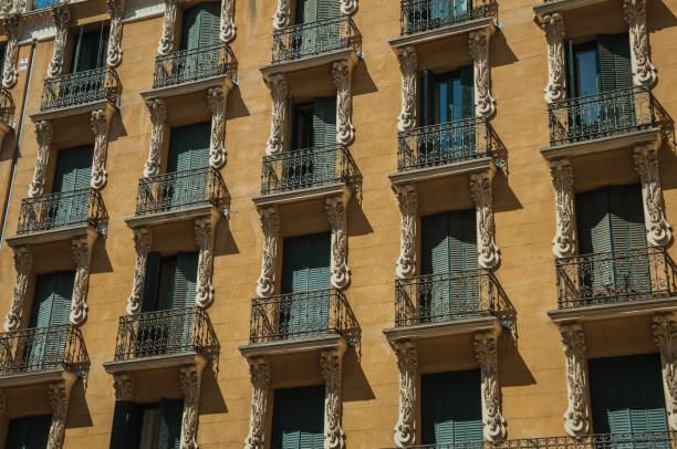 Old building with colorful facade and closed windows with iron balustrade, in a sunny day at Madrid. Capital of Spain this charming metropolis has vibrant and intense cultural life.