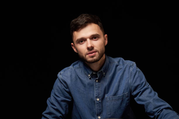 istock Handsome man in denim shirt looking at camera 1132544603