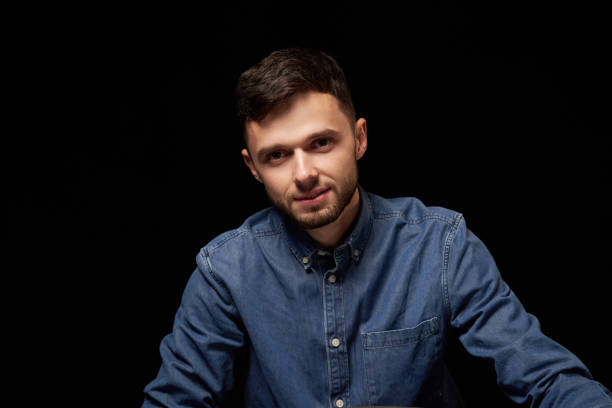 istock Handsome man in denim shirt looking at camera smiling 1132544657
