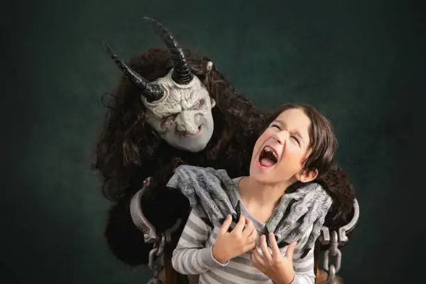 Krampus creeping on a young boy