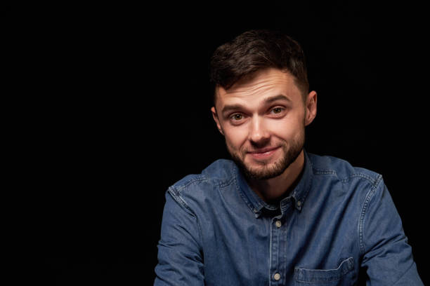istock Handsome man in denim shirt looking at camera smiling 1132544726