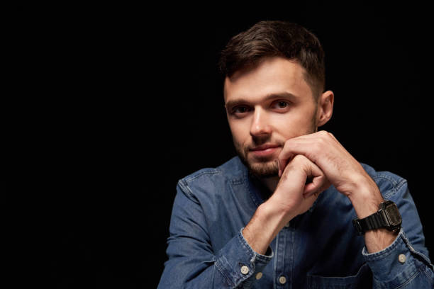 istock Handsome man in denim shirt leaning on hands looking at camera smiling 1132544773