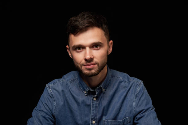 istock Handsome man in denim shirt looking at camera smiling 1132545807
