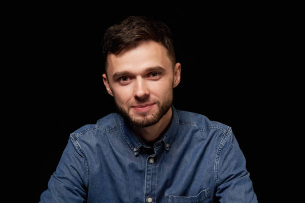 istock Handsome man in denim shirt looking at camera smiling 1132545962