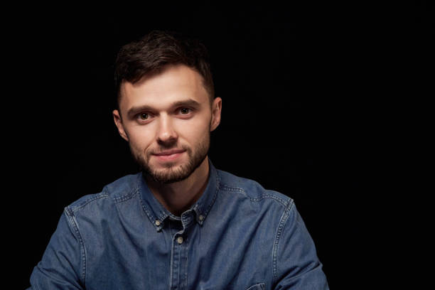 istock Handsome man in denim shirt looking at camera 1132546021