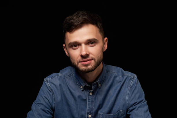istock Handsome man in denim shirt looking at camera smiling 1132546060