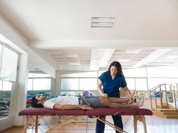 istock Physical therapist massaging patient's leg on massage table 1132546062