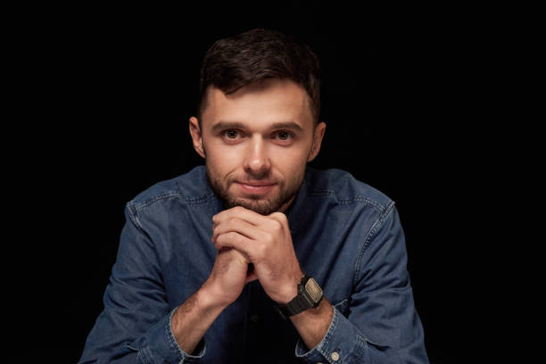 istock Handsome man in denim shirt leaning on hands looking at camera smiling 1132546132
