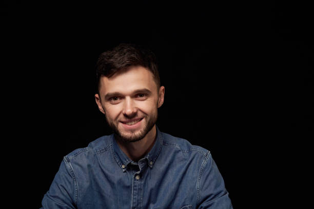 istock Handsome man in denim shirt looking at camera smiling 1132546166