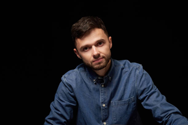 istock Handsome man in denim shirt looking at camera 1132546190