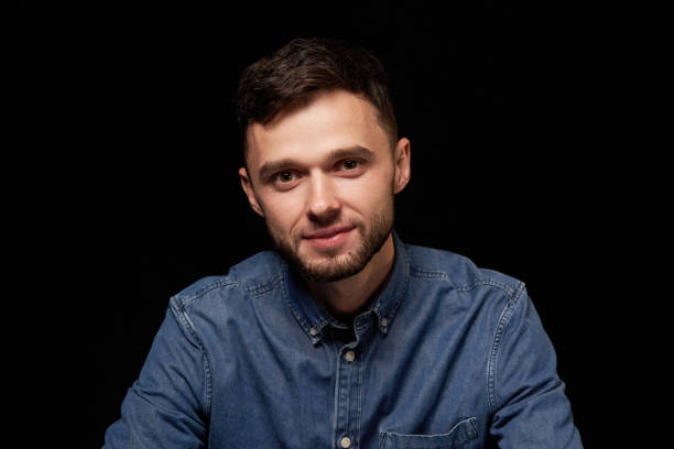 istock Handsome man in denim shirt looking at camera smiling 1132546287