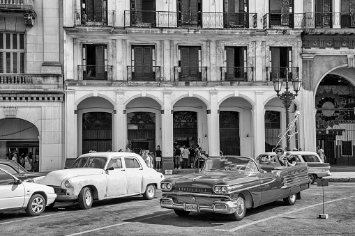 Havana, Cuba - 06 January 2013: The streets of Havana, very old American cars on the streets and horse-drawn coaches with tourists.
