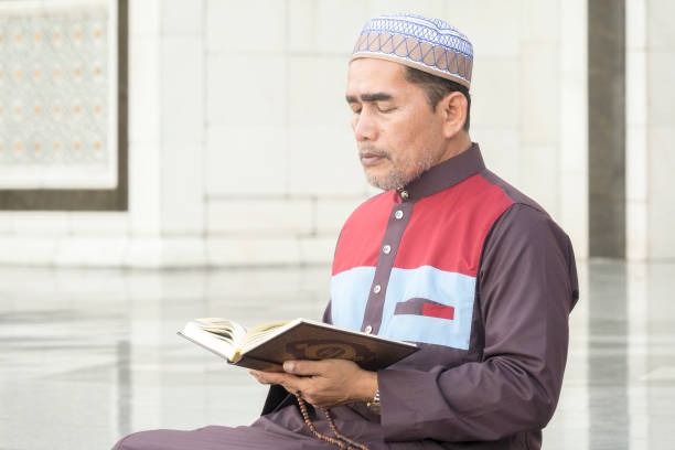 istock Mature Man Reading Koran While Sitting At Mosque 1132546612