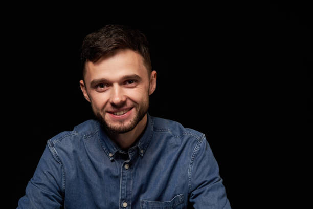 istock Handsome man in denim shirt looking at camera smiling 1132547755