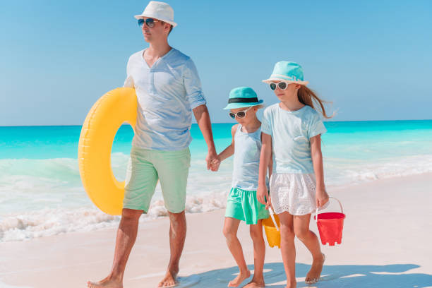 istock Father and kids enjoying beach summer vacation 1132549397