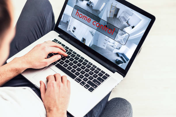 istock Man using laptop for monitoring CCTV cameras at table indoors. Home security system 1132549460