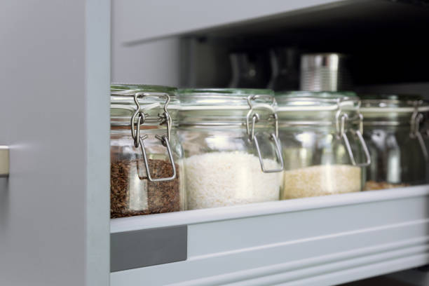 istock Various seeds in storage jars in hutch, white modern kitchen in background. Smart kitchen organization 1132552063