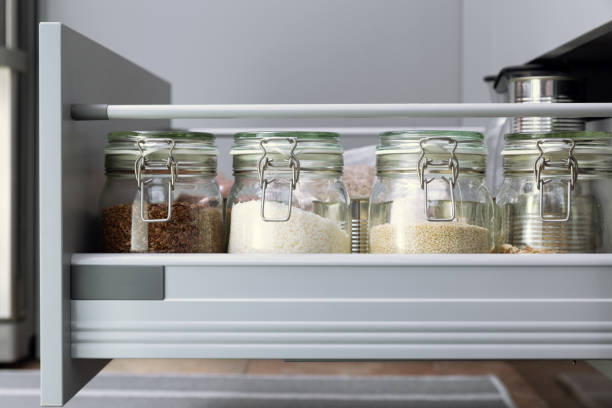 istock Various seeds in storage jars in hutch, white modern kitchen in background. Smart kitchen organization 1132552082