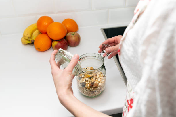 istock Women picking an item from storage hutch. Smart kitchen organization concept 1132552699