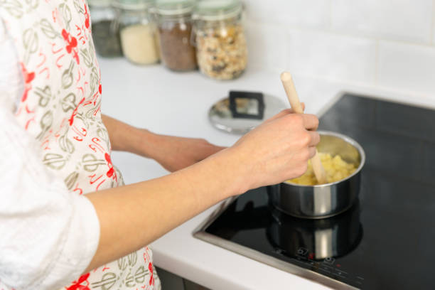 istock Supermom preparing dinner for a baby in a white modern kitchen 1132552732