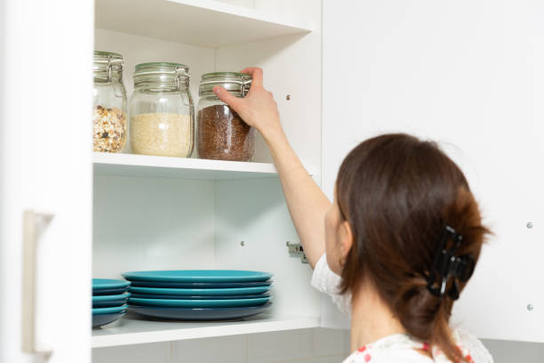 istock Women picking an item from storage hutch. Smart kitchen organization concept 1132552832