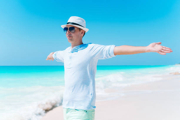 istock Young man on the white tropical beach 1132553736
