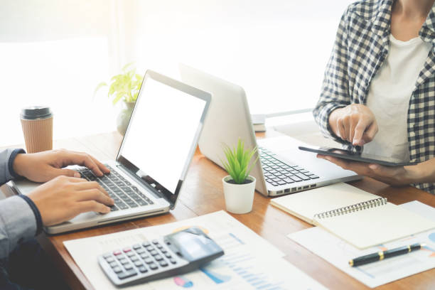 istock Midsection Of Coworkers Using Technology On Desk Against Window In Office 1132553963