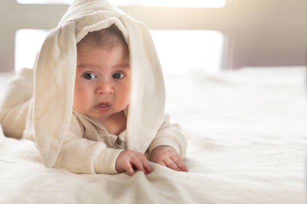 istock Having fun on Easter day. Baby boy wearing bunny costume with ears smiling. 1132554322